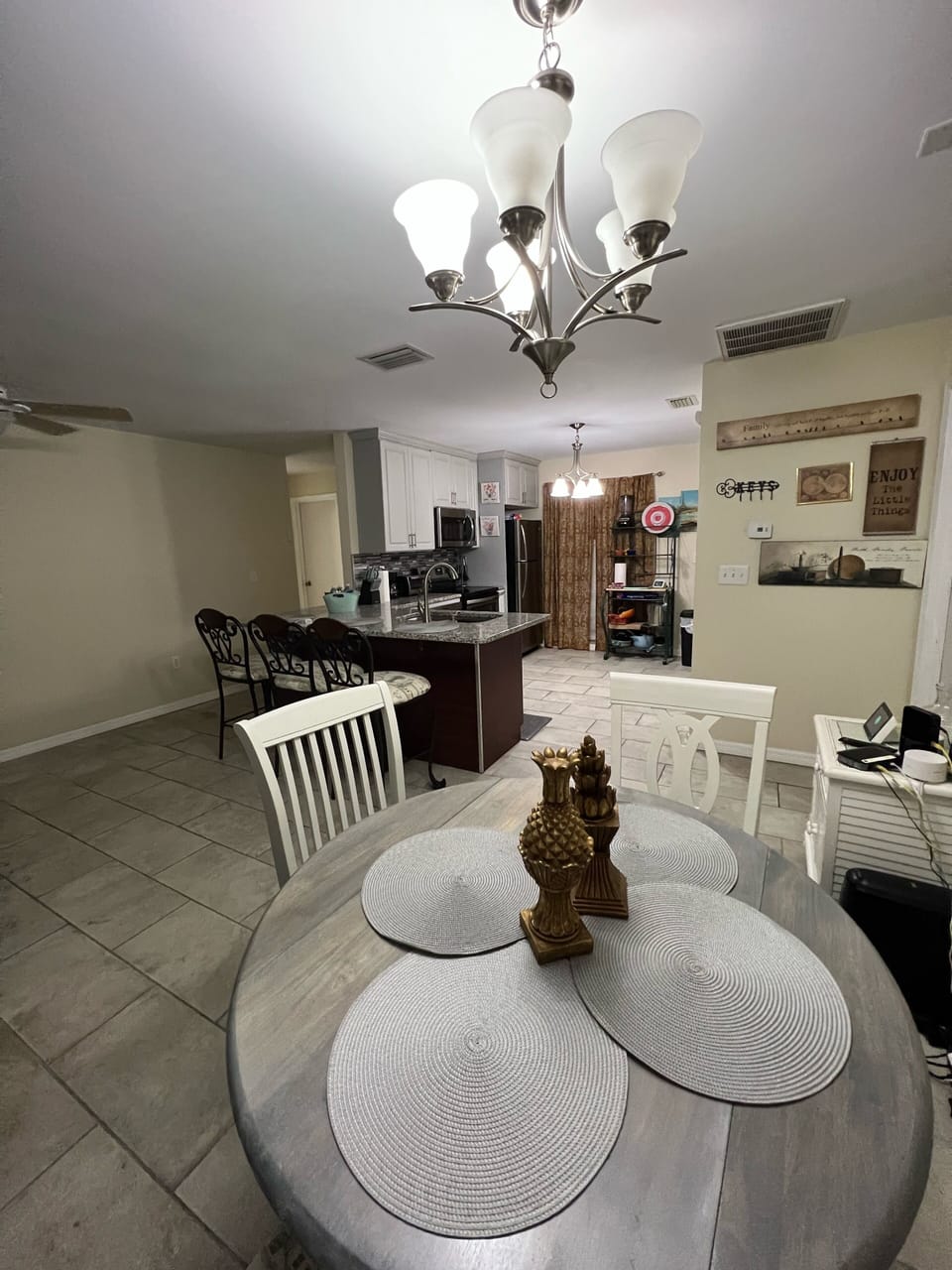 Living area & dining table for 4 plus @ 3 stools at bar