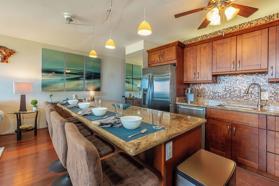 Gather around the spacious kitchen island, perfect for casual meals, morning coffee, or planning the day's adventures. The fully equipped kitchen features granite countertops, stainless steel appliances, and ample seating for family and friends.
