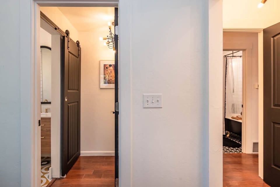 Master bathroom and guest bathroom entrances as seen from master bedroom