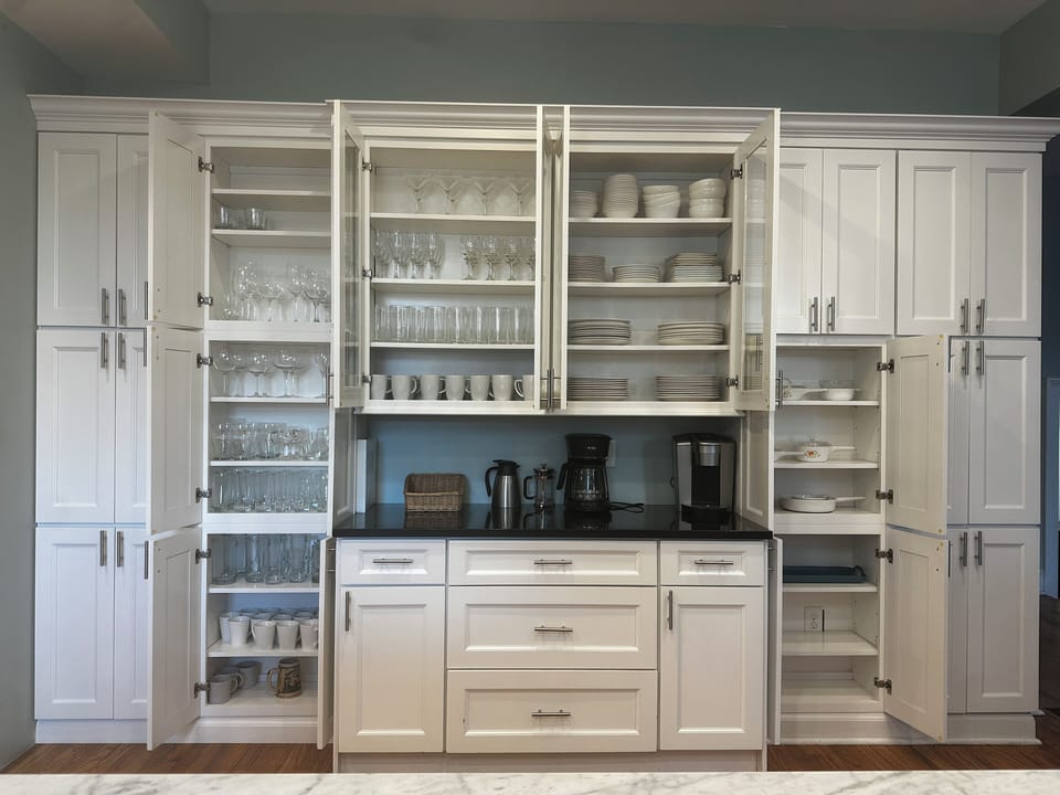 Coffee bar along with enough dinnerware and glasses for all your entertaining  