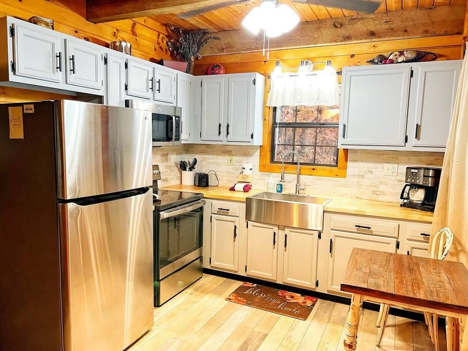 Fully equipped kitchen with stainless steel electric stove and air-fryer oven