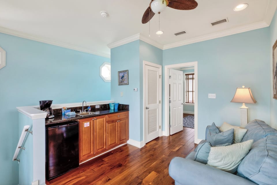 Cozy sitting area with a convenient kitchenette and French doors leading to a private outdoor space.
