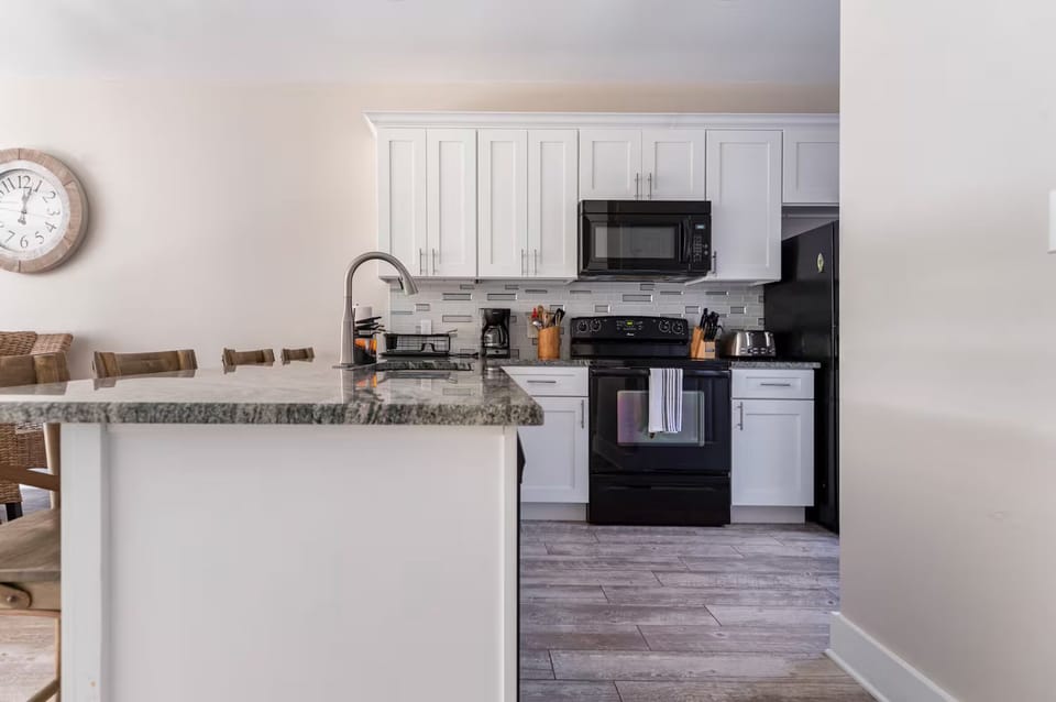 Fully stocked kitchen with coffee machine, espresso machine, blender, toaster…