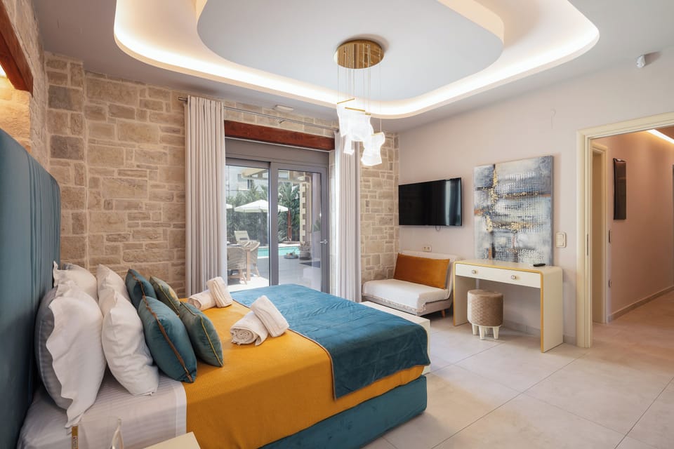 The first ensuite bedroom features a Queen size bed and direct outdoor access to the pool area
