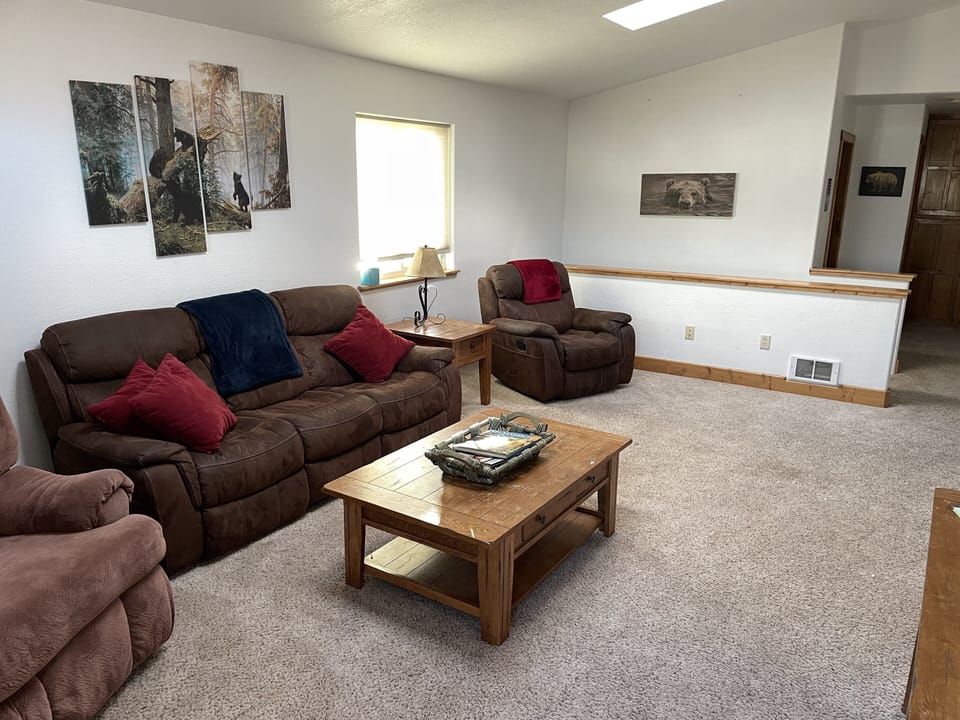 Comfy couches in front living area with cozy throws while you relax.