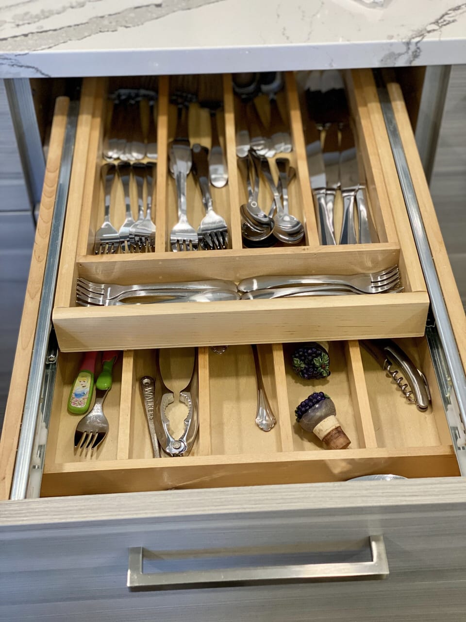 Custom cabinets stocked with pots, pans, utensils, silverware, glasses, & dishes