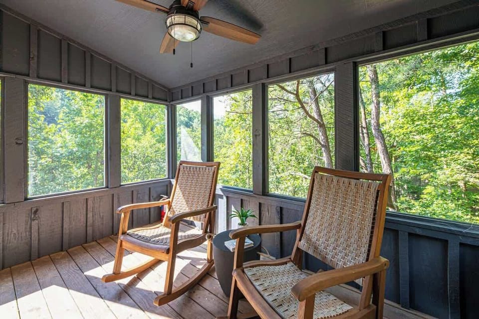 This sunroom includes rocking chairs and offers cozy reading vibes.