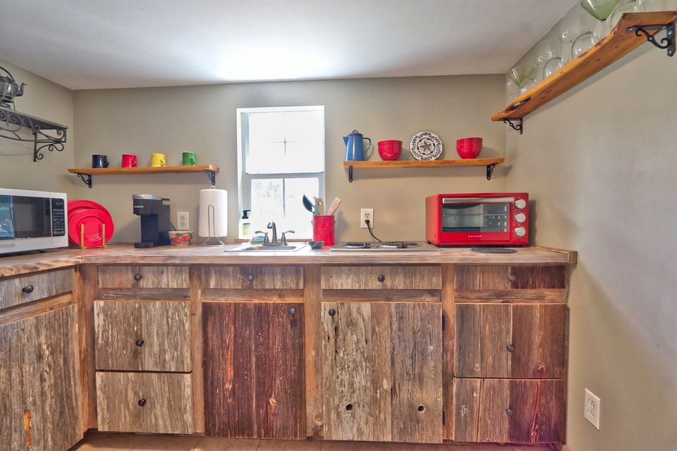 Kitchenette area with a toaster oven, sink, coffee maker, and refrigerator