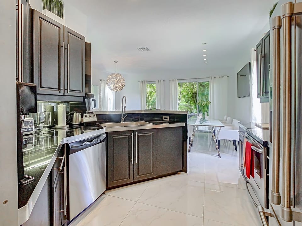 Cook with flair! Indulge in our elegant fully equipped kitchen, boasting top-of-the-line stainless steel appliances for a stylish cooking experience. 