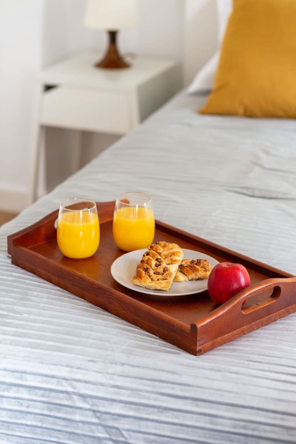 Inviting breakfast setup on a bed, adding a touch of luxury and comfort.