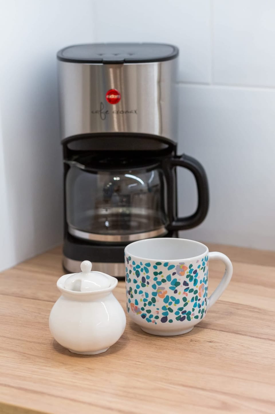 Close-up of a kitchen counter with a coffee station.