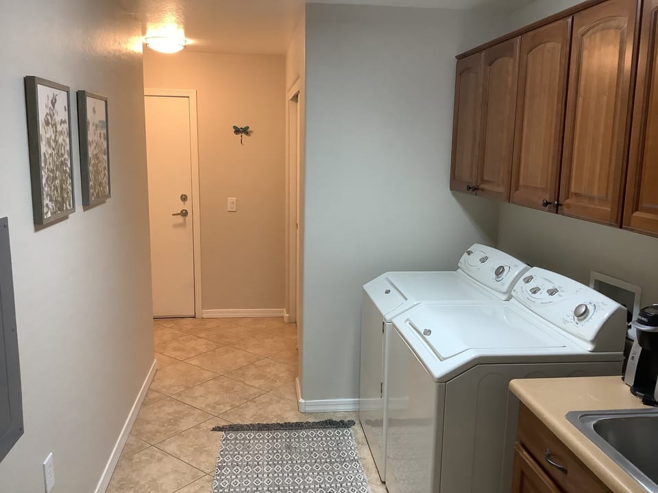 Laundry room with washer and dryer and door to garage