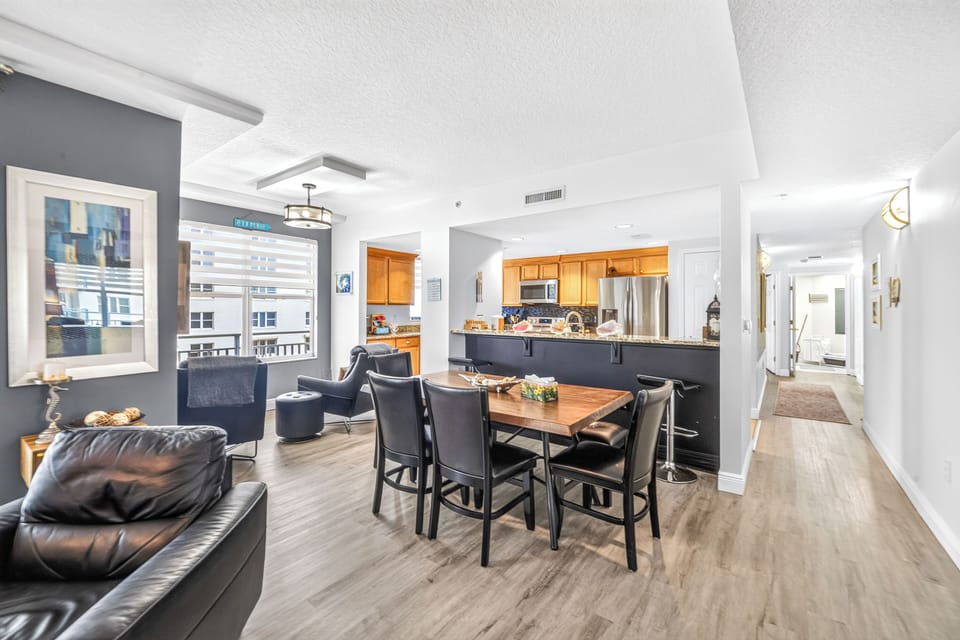 Gather around the spacious dining table in your open-concept living area. With a fully equipped kitchen and views of the city skyline just beyond, this inviting space makes every meal memorable.