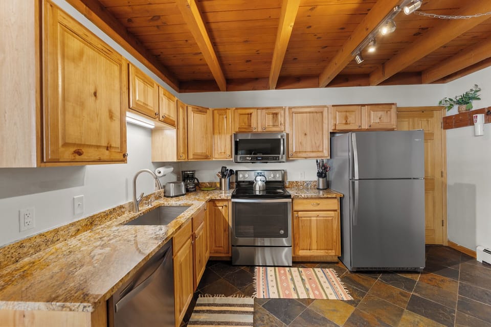 Updated full size kitchen with granite countertops and stainless steel appliances.