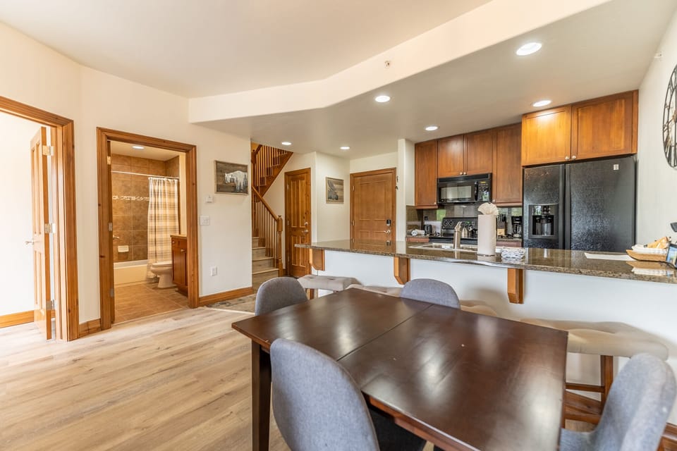 Gather around your spacious dining table where warm wood tones and granite countertops create the perfect setting for memorable meals together.