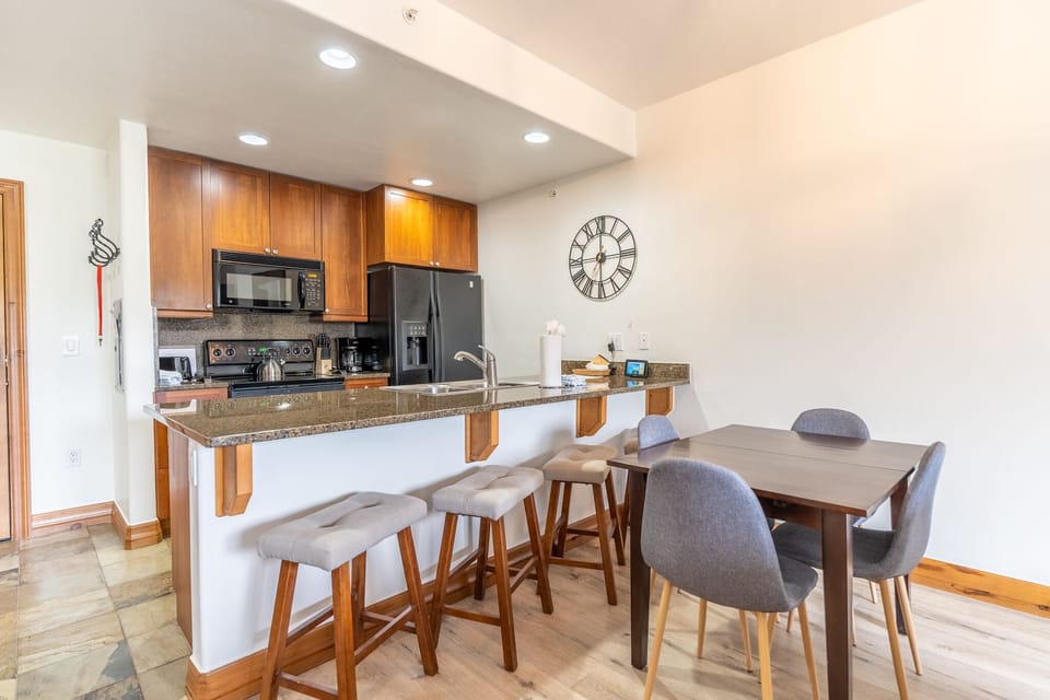 Step into your stylish open-concept kitchen and dining space, where granite countertops and modern appliances invite you to create memorable meals together.