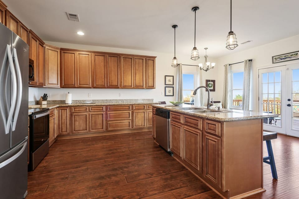 Gourmet kitchen w/ stainless steel appliances, granite countertops, and VIEWS. 