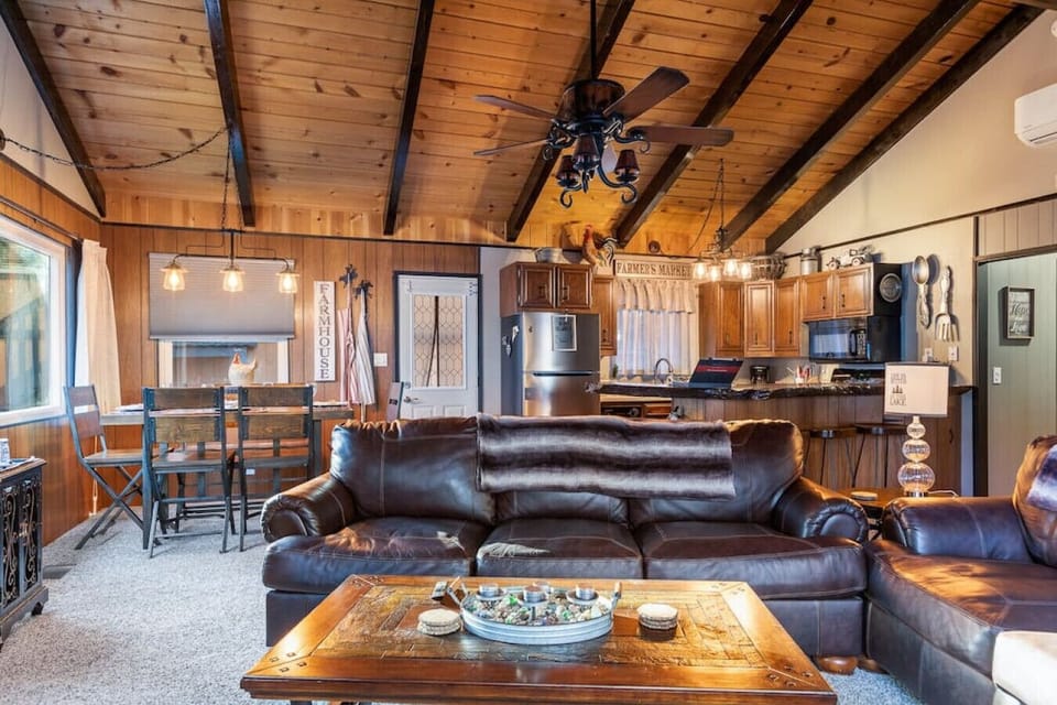 Large open concept living room with beautiful word work, views of the pine trees and a short walk to the Lake this cabin is perfect and in an upscale neighborhood near the Village!