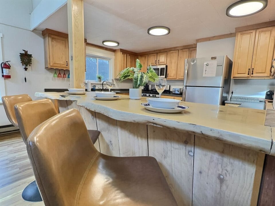 Enjoy a meal at this unique live-edge breakfast bar, the heart of our fully equipped kitchen.