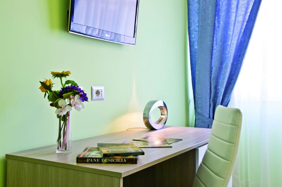 Triple Room | Minibar, in-room safe, individually decorated, desk