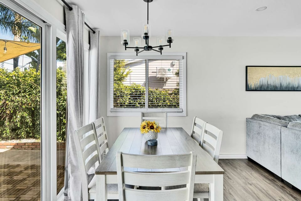 Dining area features a modern table with sleek decor, creating an inviting atmosphere.