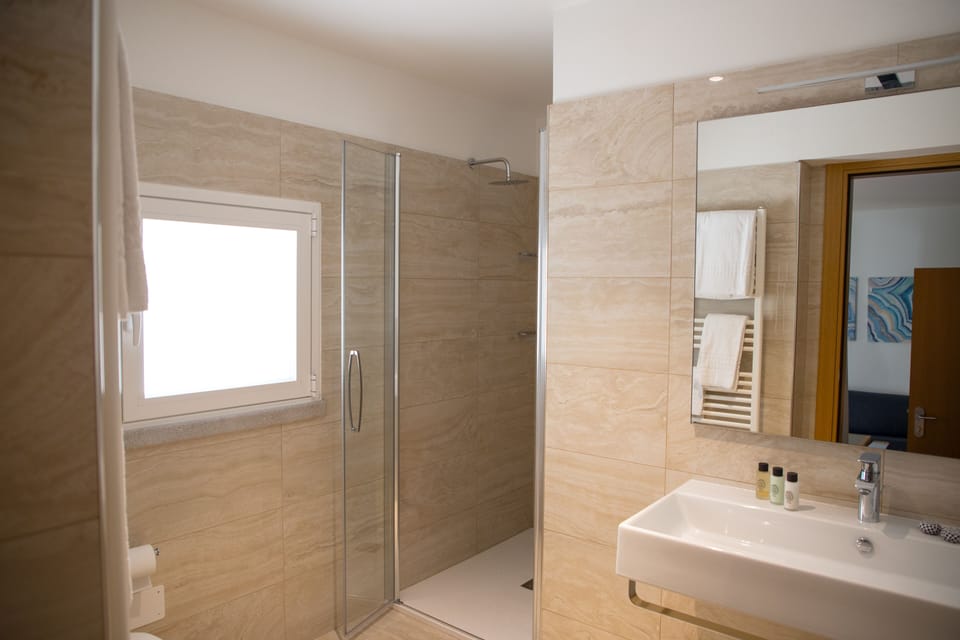 Shower, rainfall showerhead, designer toiletries, hair dryer