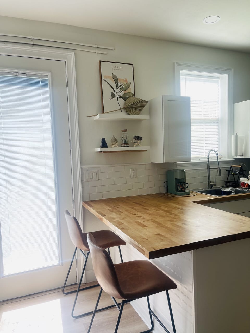 Large Butcher Block counters for easy dining! Leather barstools - natural light