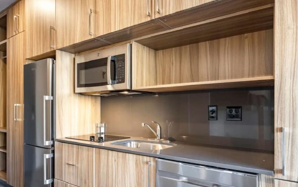 Kitchen includes a flat-top stove, microwave, refrigerator/freezer, dishwasher