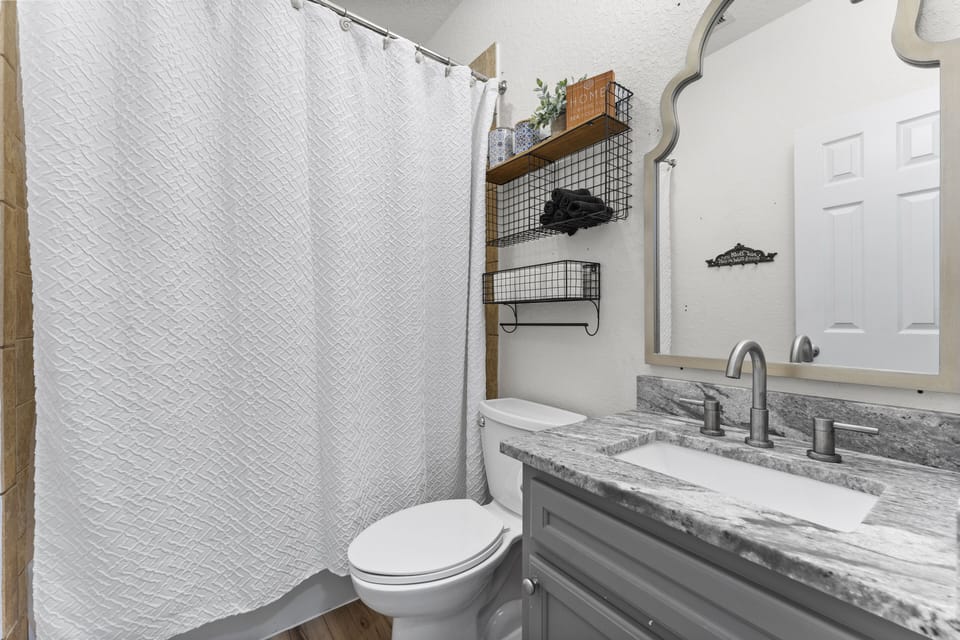 Full bath with tub/shower combo.