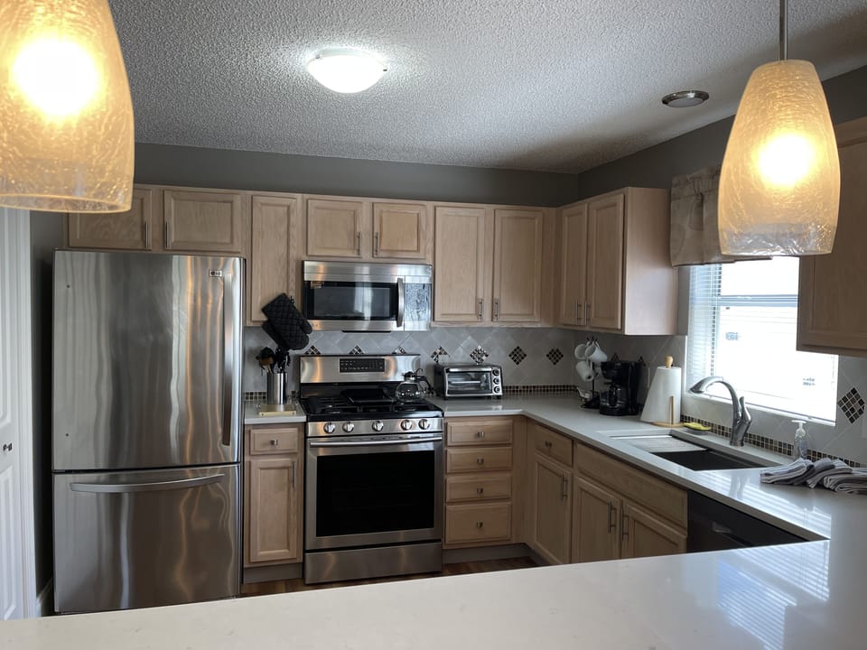 Well stocked kitchen with stainless steel appliances