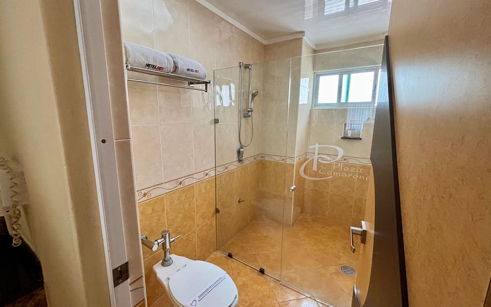 Standard Double Room | Bathroom | Shower, hair dryer, slippers, towels