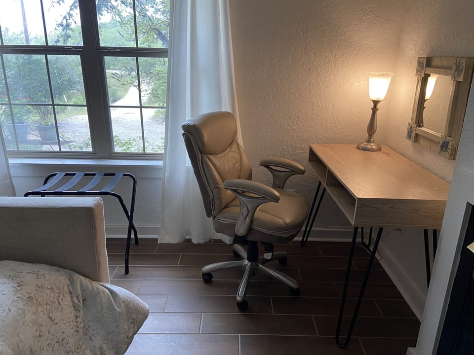 Desk and office chair in bedroom.