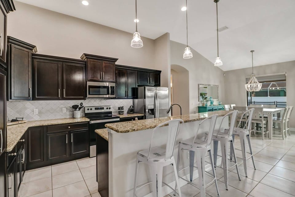 An island with eating bar with 4 bar stools separates the kitchen from the main living space.