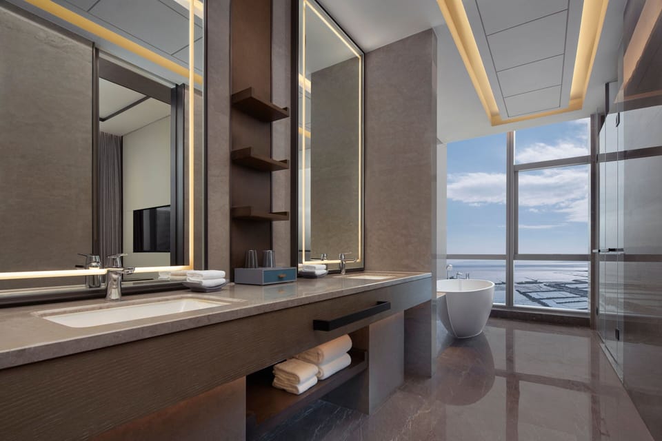 Suite, 1 King Bed, City View | Bathroom | Free toiletries, hair dryer, bathrobes, slippers