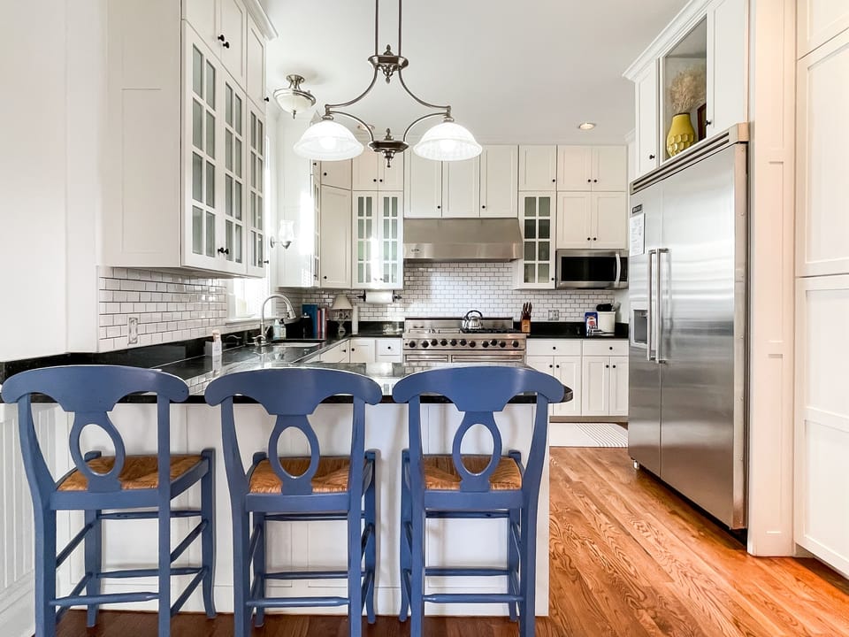 The beautifully detailed full kitchen has everything you need to make your own meals, including modern appliances, place settings, pots and pans, and wine glasses at Mill Haus.