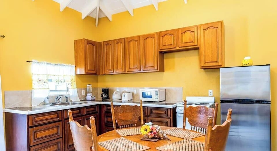 The kitchen and table for preparing and enjoying meals at home.