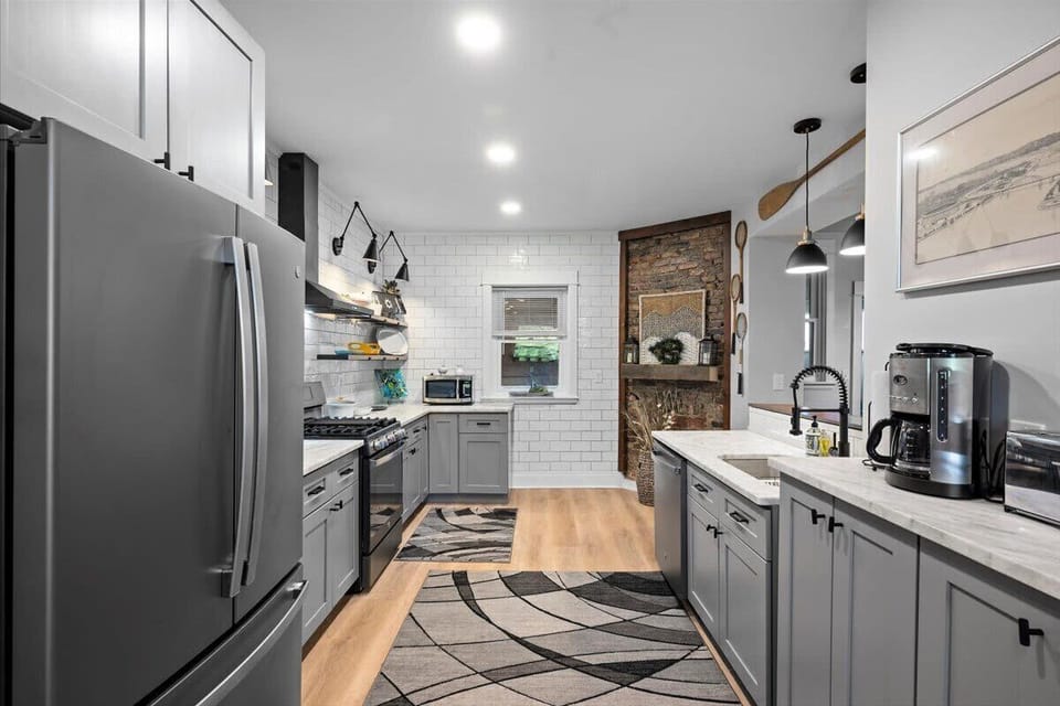 A view from the kitchen into the dining area, this home features so much character, check out that exposed brick!
