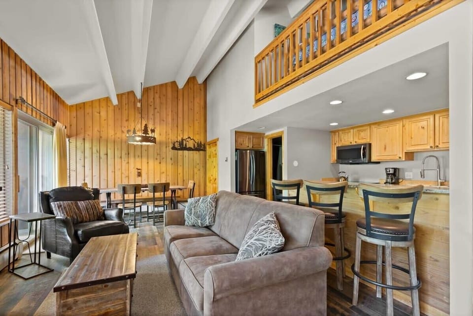 View of the family room, fully-equipped kitchen, and dining area