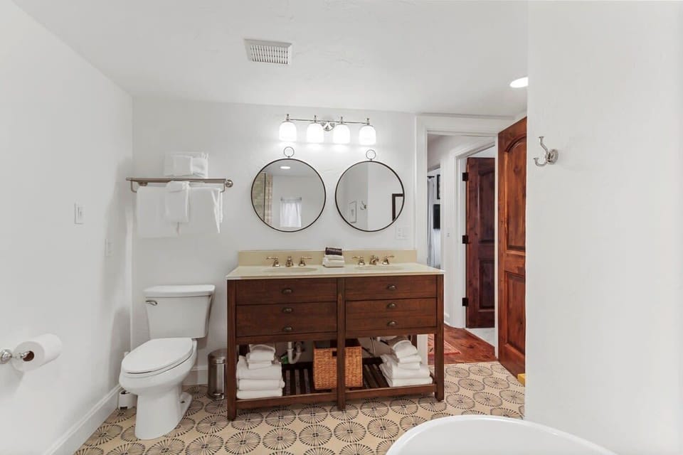 4th level shared full bathroom with a large tub and walk-in shower