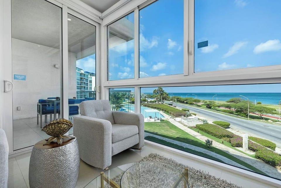 Curl up in your cozy balcony retreat with stunning pool and ocean views stretching to the horizon. The perfect spot to unwind and soak in the coastal breeze.