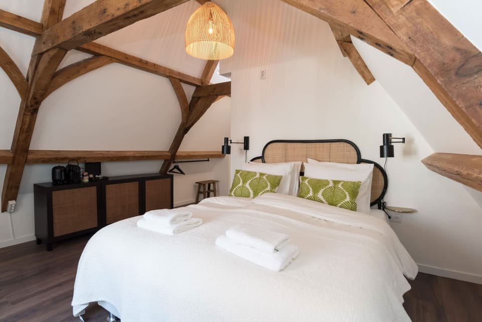 Cozy double bed in romantic attic room