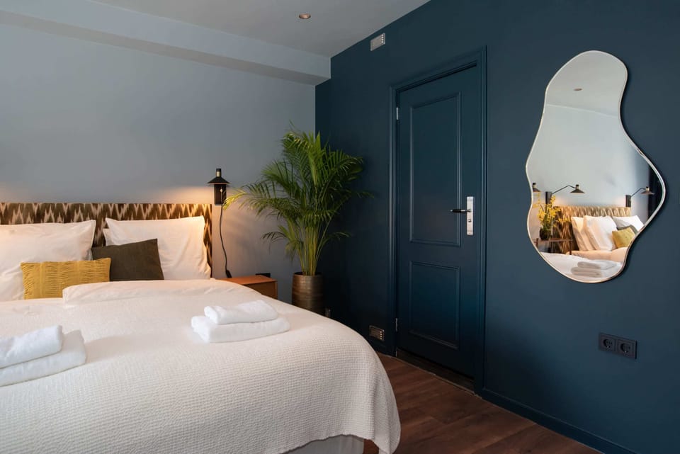 Two comfy double beds and door to the bathroom