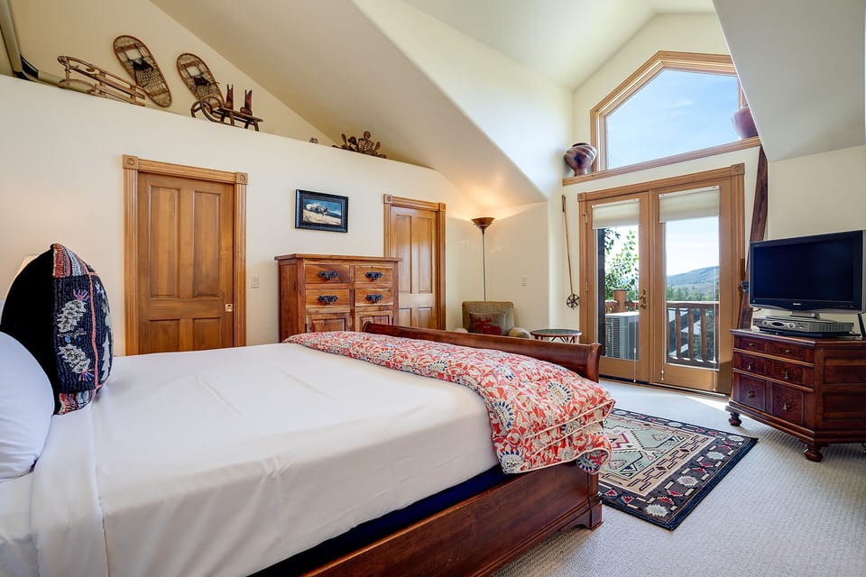 Your mountain bedroom combines rustic charm with modern comfort, featuring a plush king bed and private balcony access to breathe in crisp alpine air.
