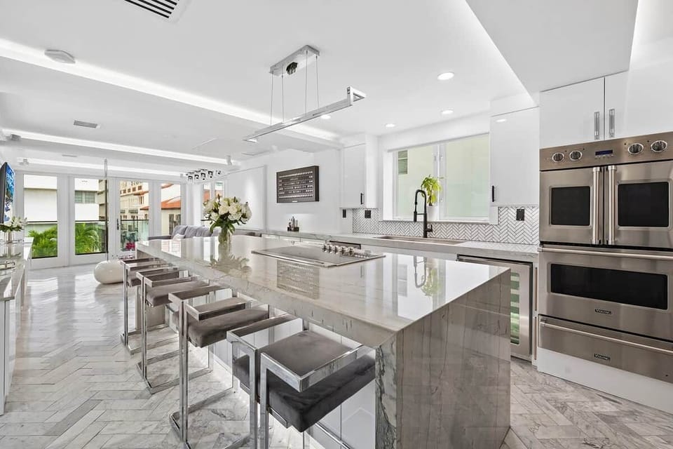 3rd FLOOR: KITCHEN. 30 foot island. Viking appliances (double oven, warmer, full fridge, wine fridge, dishwasher, drawer microwave, 6 burner cooktop with retractable vent, dishwasher), built-in Miele espresso machine. 48 inch sink. 