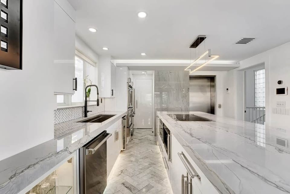 3rd FLOOR: KITCHEN. 30 foot island. Viking appliances (double oven, warmer, full fridge, wine fridge, dishwasher, drawer microwave, 6 burner cooktop with retractable vent, dishwasher), built-in Miele espresso machine. 48 inch sink. Private elevator.