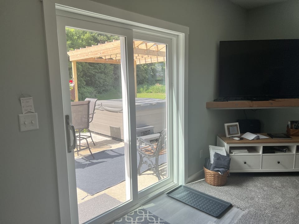 Sliding glass doors provide a private entrance to the lower level. 