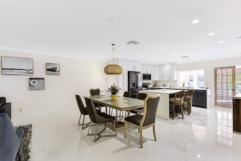 Dining area with seating for six, ideal for family meals or gathering with friends.