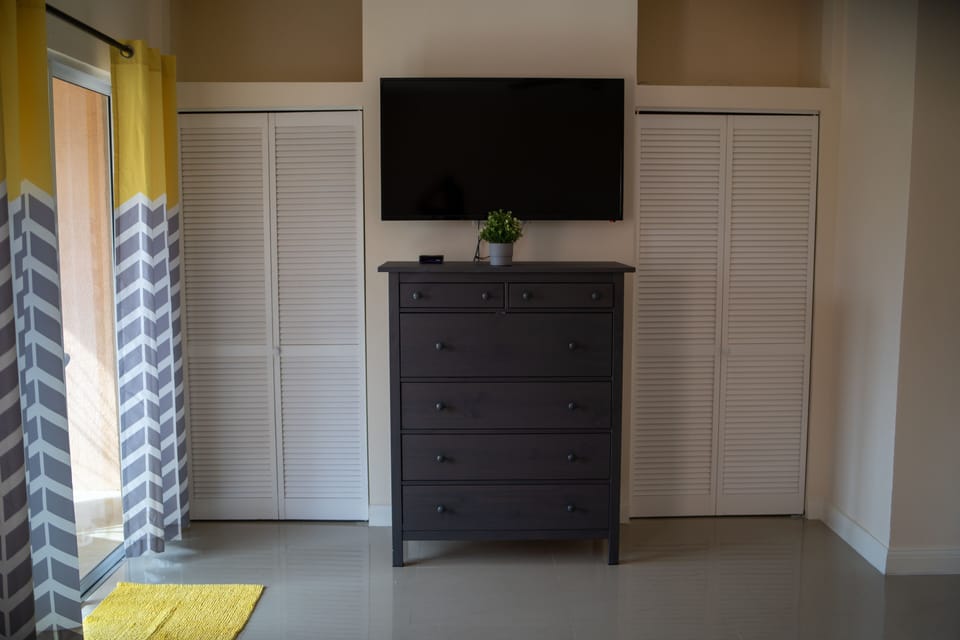 Master suite TV and patio door to upper porch 