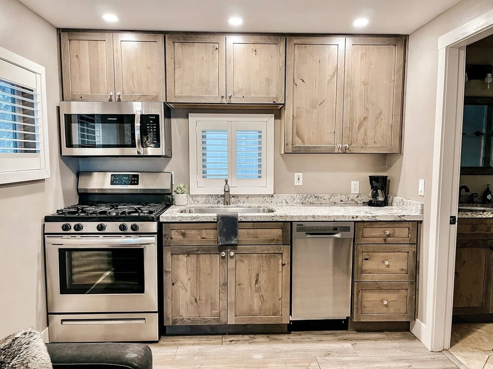 Full kitchen with granite countertops & new appliances. Bathroom to the right.