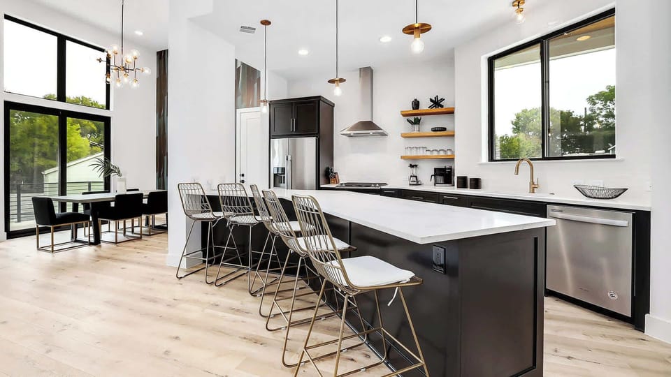 Kitchen island with seating for 6 right near the dining table that also seats 6